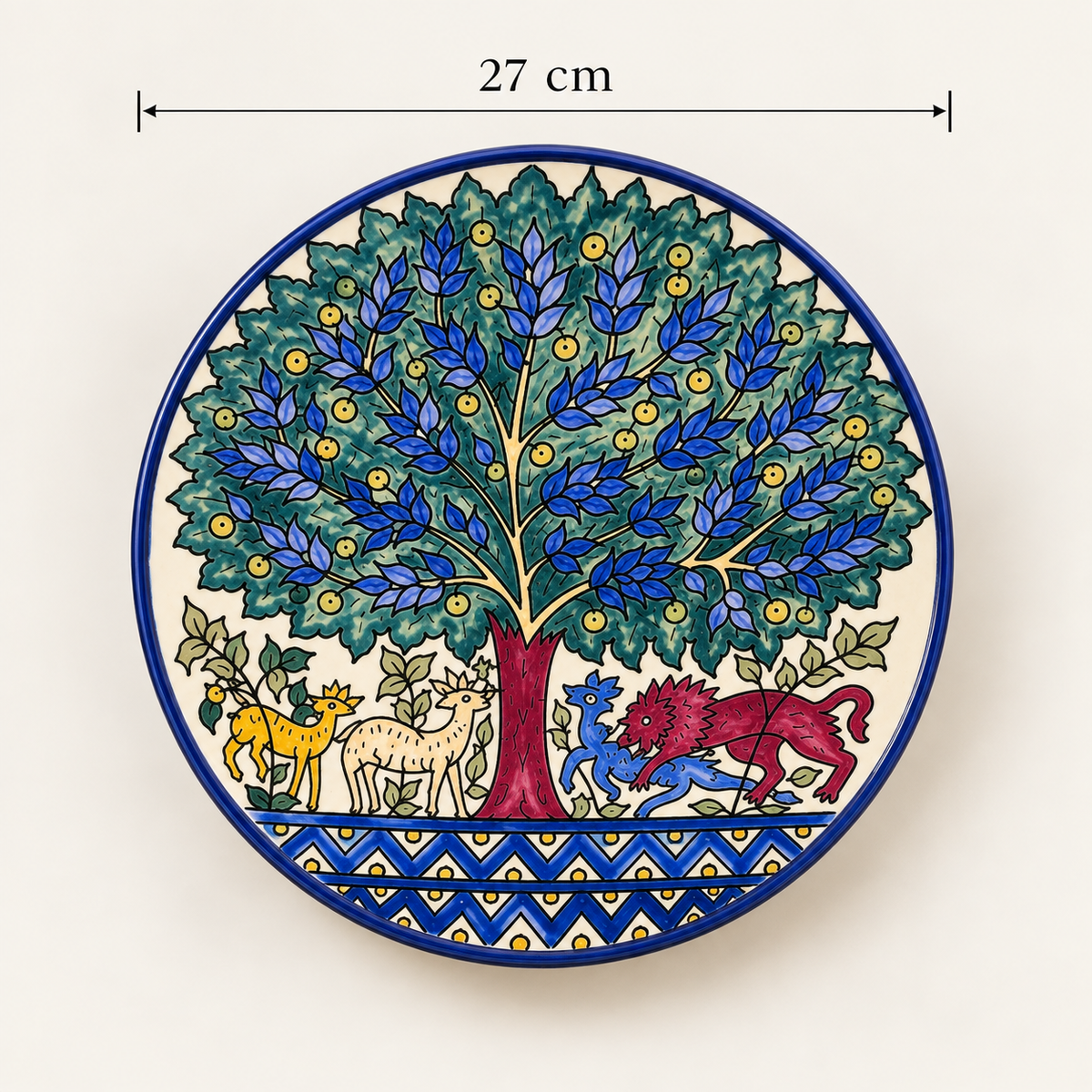 A round ceramic wall plaque featuring a hand-painted tree of life design with blue and green leaves, a red trunk, and various animals under the tree. The plaque is shown against a plain off-white background with a dimension line indicating a width of 27 cm.